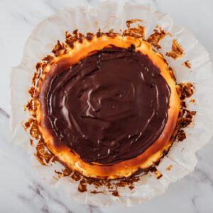 Chocolate ganache homemade topped over cheesecake