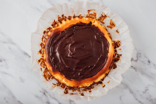 Chocolate ganache homemade topped over cheesecake