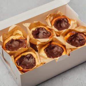 Ganache chocolate topping minicheesecakes in a box