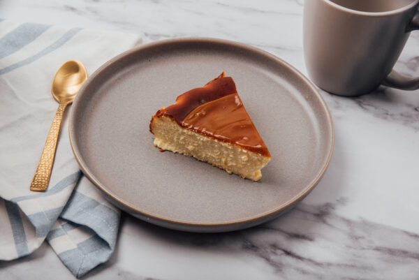 Cheesecake slice with dulce de leche topping