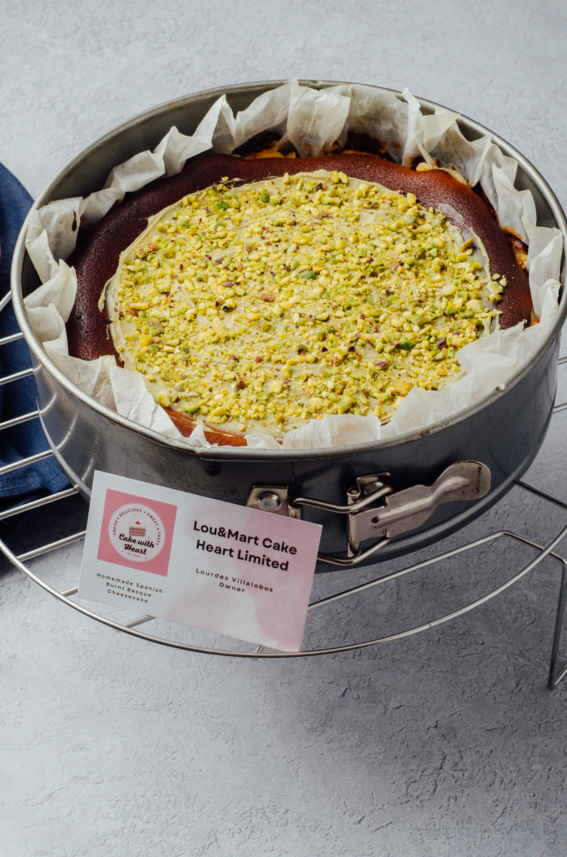 Pistachio baked cheesecake with chopped pistachio topped and pistachio spread at the top of cheesecake